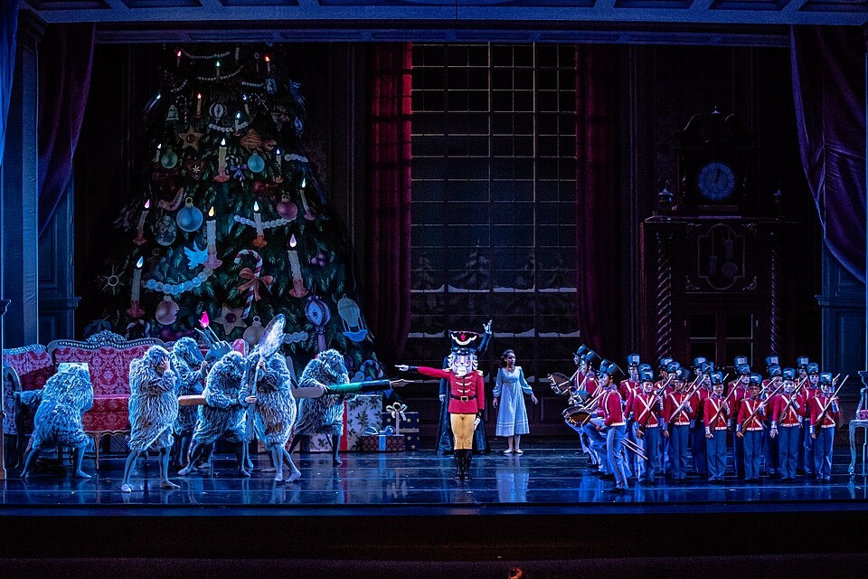 A scene from The Nutcracker ballet showing toy soldiers facing off against mice in a grand, festive setting, reflecting how ballet has changed through time in storytelling, costumes, and stage design.
